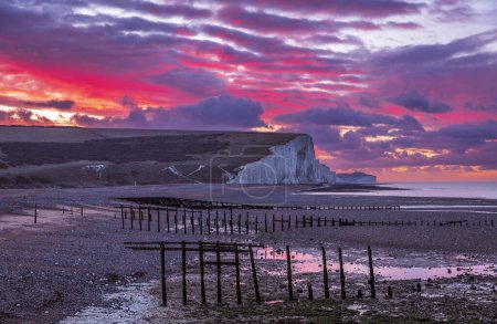Téléchargez les photos : Ciel rouge dramatique aube au-dessus de Cuckmere Haven marée basse sur la côte est du Sussex sud-est de l'Angleterre Royaume-Uni - en image libre de droit