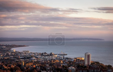 Photo for January sunrise from Beachy head over the coastal town of Eastbourne on the east Sussex coast south east England UK - Royalty Free Image