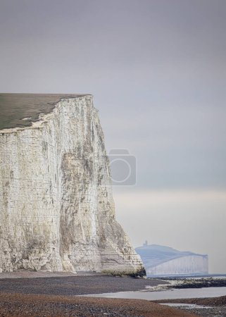 Photo for The steep chalk face cliffs of Haven Brow and the seven sisters at low tide from Cuckmere Haven on the east Sussex coast, south east England UK - Royalty Free Image