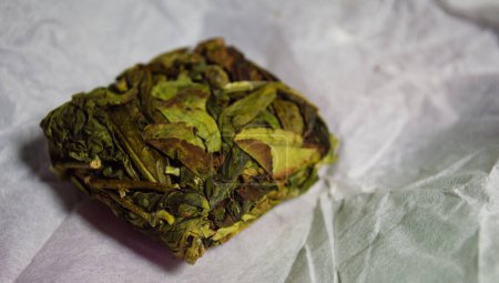 Photo for Pressed briquette of "Oolong" tea in a white package - Royalty Free Image