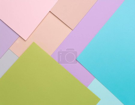 Colorful paper sheets arranged in pastel palette for creative background