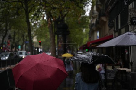 Photo for Paris, France, 27.07.2023: Pedestrians with umbrellas in rainy Paris. - Royalty Free Image