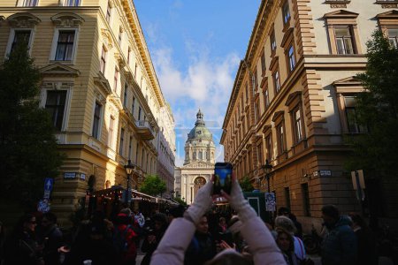 Photo for Budapest, Hungary - November 18, 2023: Tourist takes photo of St. Stephen's Basilica. - Royalty Free Image