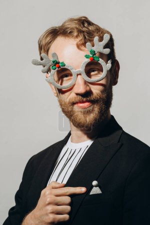 Photo for Young man in black jacket with party glasses on color background. - Royalty Free Image