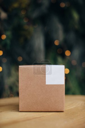Photo for Mockup. Kraft paper boxes with white stickers on Christmas background. - Royalty Free Image