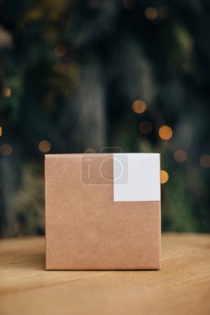 Photo for Mockup. Kraft paper boxes with white stickers on Christmas background. - Royalty Free Image