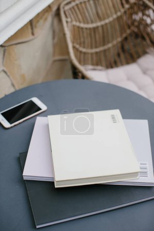 Photo for Mockup image magazine book and phone at the local table in the coffee shop. - Royalty Free Image