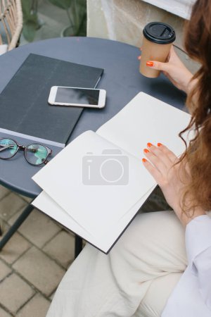 Photo for Mockup image magazine book. The girl at the coffee shop table reading book. - Royalty Free Image