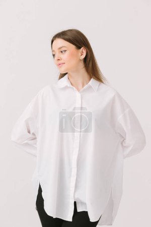 Foto de Photo of a pretty woman in a white shirt isolated on a white background. Shirt mockup. - Imagen libre de derechos
