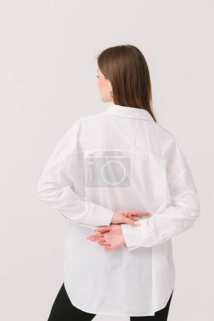 Foto de Photo of a pretty woman in a white shirt isolated on a white background. Shirt mockup. - Imagen libre de derechos
