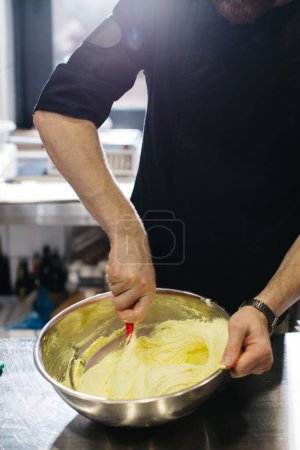 Photo for The chef works in the kitchen. The process of making dough for macaroons. - Royalty Free Image