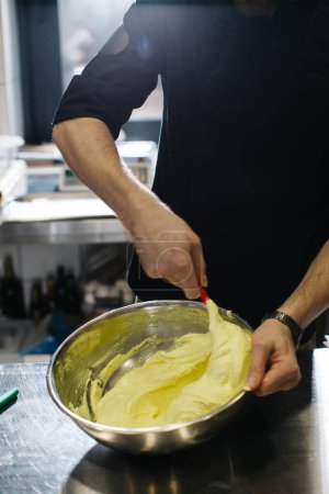 Photo for The chef works in the kitchen. The process of making dough for macaroons. - Royalty Free Image