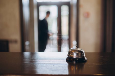 Photo for Arrival at the hotel. Reception desk with a bell in the hotel lobby. - Royalty Free Image