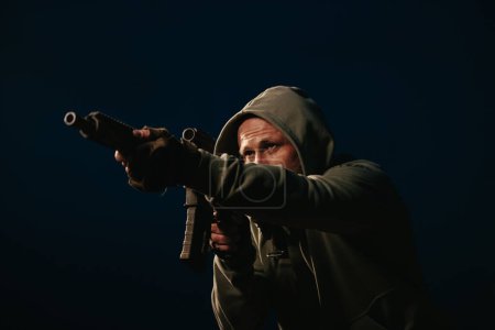Photo for Male Ukrainian defender aiming his rifle at night - Royalty Free Image