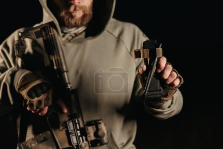 Ukrainian armed military man holding a medical tourniquet