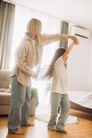 Photo for Mom and her daughter child girl are dancing. Family holiday and togetherness. - Royalty Free Image