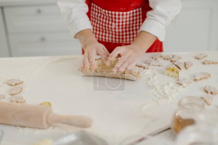 Photo for Close-up of little girl's hands kneading dough at the kitchen table. - Royalty Free Image