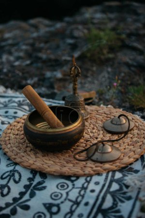 Photo for Tibetan copper singing bowl, meditation and alternative medicine items, outdoor. - Royalty Free Image