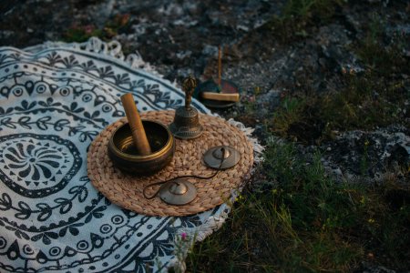 Photo for Tibetan copper singing bowl, meditation and alternative medicine items, outdoor. - Royalty Free Image