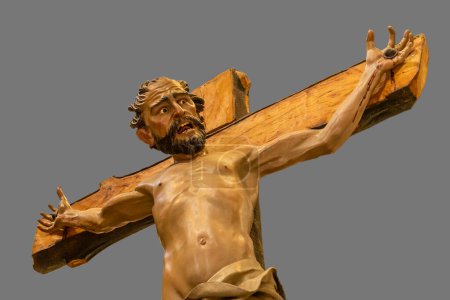 Photo for Polychrome wood carving of a thief crucified next to Christ. This wooden carving is part of the Calvary of Christ and goes out in procession during Holy Week in Zamora, Spain. - Royalty Free Image