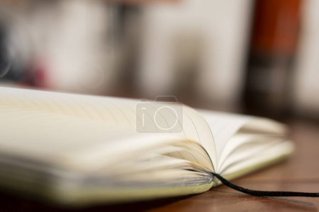 Photo for An open journal and warm light illuminating blank pages - Royalty Free Image