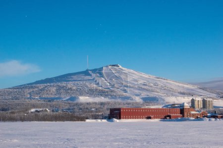 View of the mountain Loussavaara and the newly built housing next to it on a sunny winter day. Kiruna in Swedish Lapland, Northern Scandinavia.
