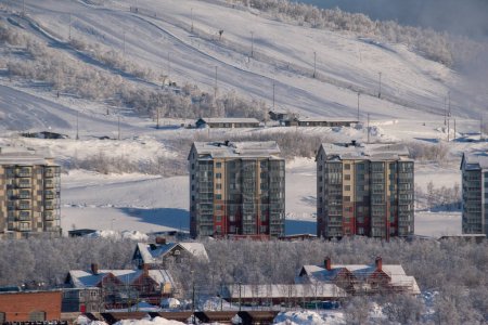 View of the mountain Loussavaara and the newly built housing next to it on a sunny winter day. Kiruna in Swedish Lapland, Northern Scandinavia.