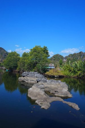 Photo for Maros Rammang-Rammang, panoramic views of clear rivers and shell rocks overlooking trees and mountains - Royalty Free Image