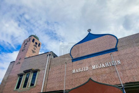 Artistic front view of the mosque against the blue sky in the afternoon