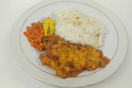 Rice mixed with fried fish and tempeh vegetables on a white plate