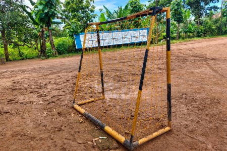 Futsal goal posts on red soil in the afternoon