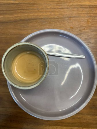 Photo for Close up view of a cup of coffee with saucer on wooden surface, top view - Royalty Free Image