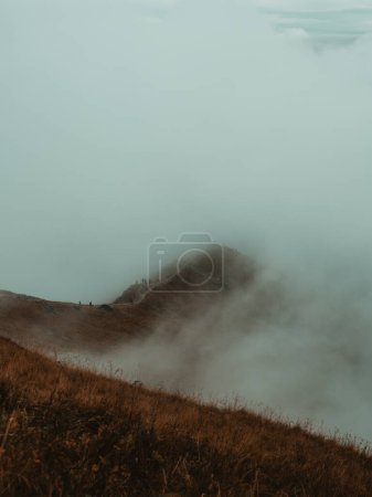 Photo for Trails of mystic ascent: A mountain shrouded in delicate fog, where small trails weave through the mysterious mist, inviting exploration into the heart of nature's tranquil grandeur. - Royalty Free Image