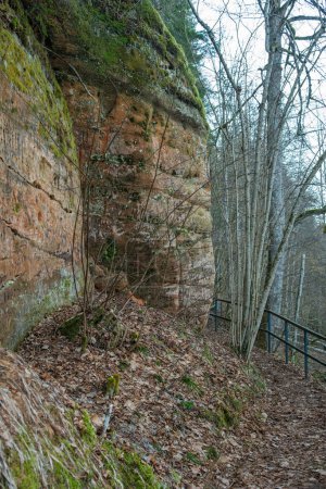 The red cliffs of Cesis beckon adventurers to explore their rugged terrain and uncover the mysteries hidden within