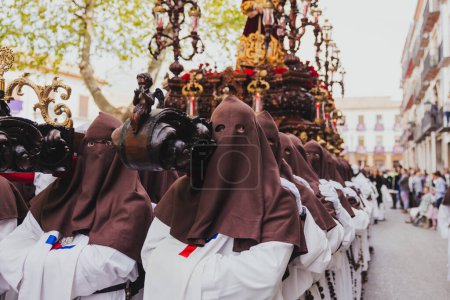 Photo for Holy Week procession with nazarenes carrying on their shoulders a throne of Jesus, concept of Holy Week. - Royalty Free Image