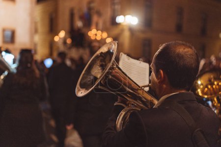 Téléchargez les photos : Musicien le dos au premier plan jouant de la trompette la nuit - en image libre de droit