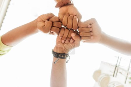 Photo for Group with fists together. - Royalty Free Image