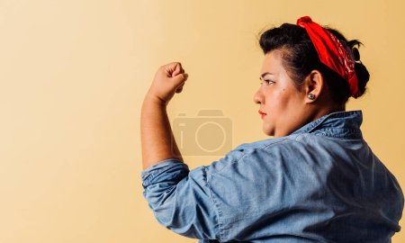 Téléchargez les photos : Vue de côté portrait de la femme montrent sa force. concept de féminisme. - en image libre de droit