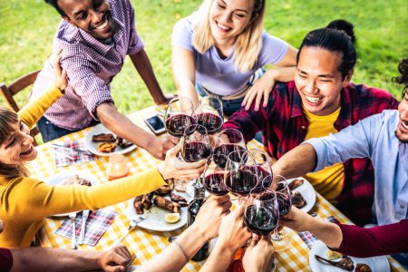 Multiracial people eating food at barbecue backyard home party