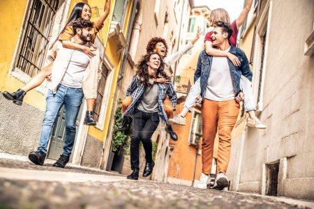 Photo for Millennial people having fun walking on city street. Young tourists visiting european town. Youth and tourism concept - Royalty Free Image