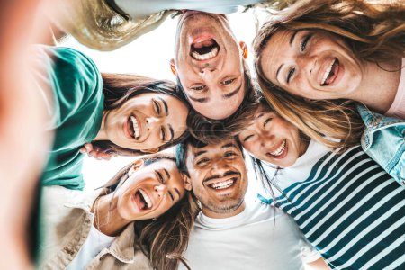 Photo for Happy young people smiling at camera together. Youth community concept with guys and girls hugging outdoors - Royalty Free Image