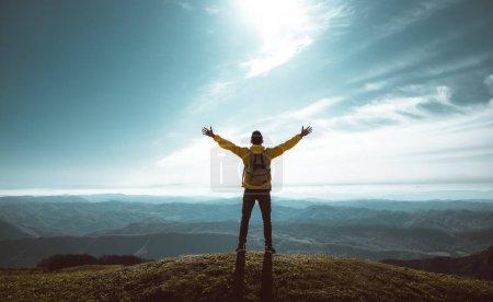Photo for Hiker with arms up standing on the top of the mountain - Successful man enjoying triumph - Sport and success concept - Royalty Free Image