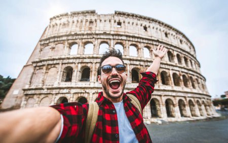 Foto de Feliz turista visitando el Coliseo en Roma, Italia - Joven tomando selfie frente a famoso hito italiano - Viajes y concepto de vacaciones - Imagen libre de derechos