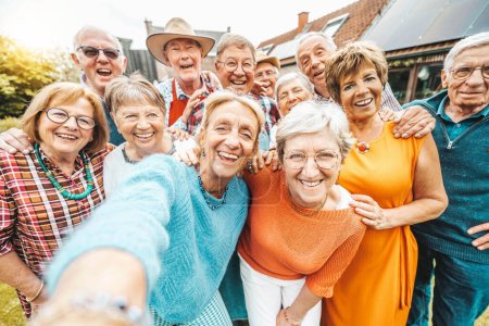 Photo for Happy group of senior people smiling at camera - Older friends taking selfie pic with smart mobile phone device - Pensioners having fun together on holiday - Royalty Free Image