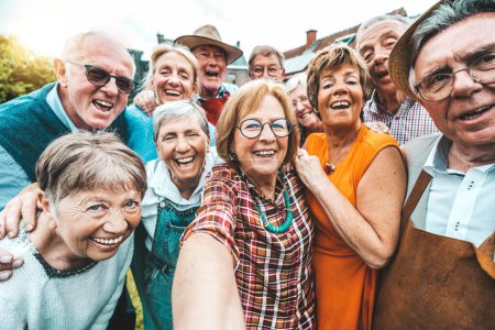 Photo for Group of senior people smiling at camera - Aged friends taking selfie pic with smart mobile phone device -Pensioners having fun together on holiday - Royalty Free Image