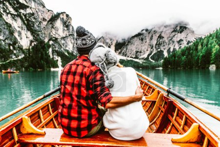 Photo for Romantic couple on a boat visiting an alpine lake at Braies Italy. Tourist in love spending loving moments together at autumn mountains. Concept about travel, couple and wanderust. - Royalty Free Image