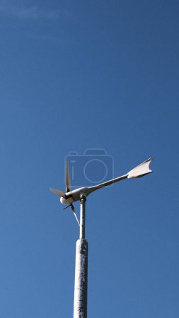 Photo for A wind turbine on top of a metal pole - Royalty Free Image