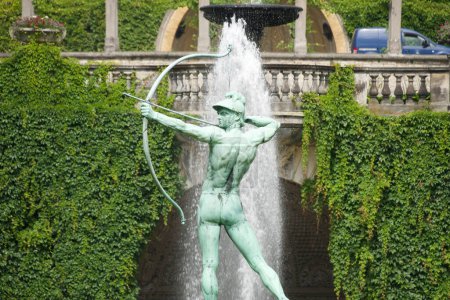Photo for This lively sculpture of an archer set against a backdrop of lush greenery and a flowing fountain encapsulates the vibrant spirit of Potsdam public art. - Royalty Free Image
