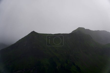 Photo for The green slopes of the Swiss Alps are shrouded in mist, creating a mysterious and enchanting mountain landscape. - Royalty Free Image