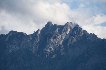 Photo for The rugged peaks of the Swiss Alps reach towards the cloudy skies, embodying the majestic and untamed spirit of the mountains. - Royalty Free Image